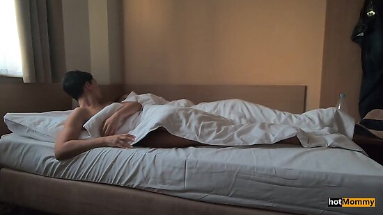 The son and his mother stayed at a hotel and slept in the same bed.